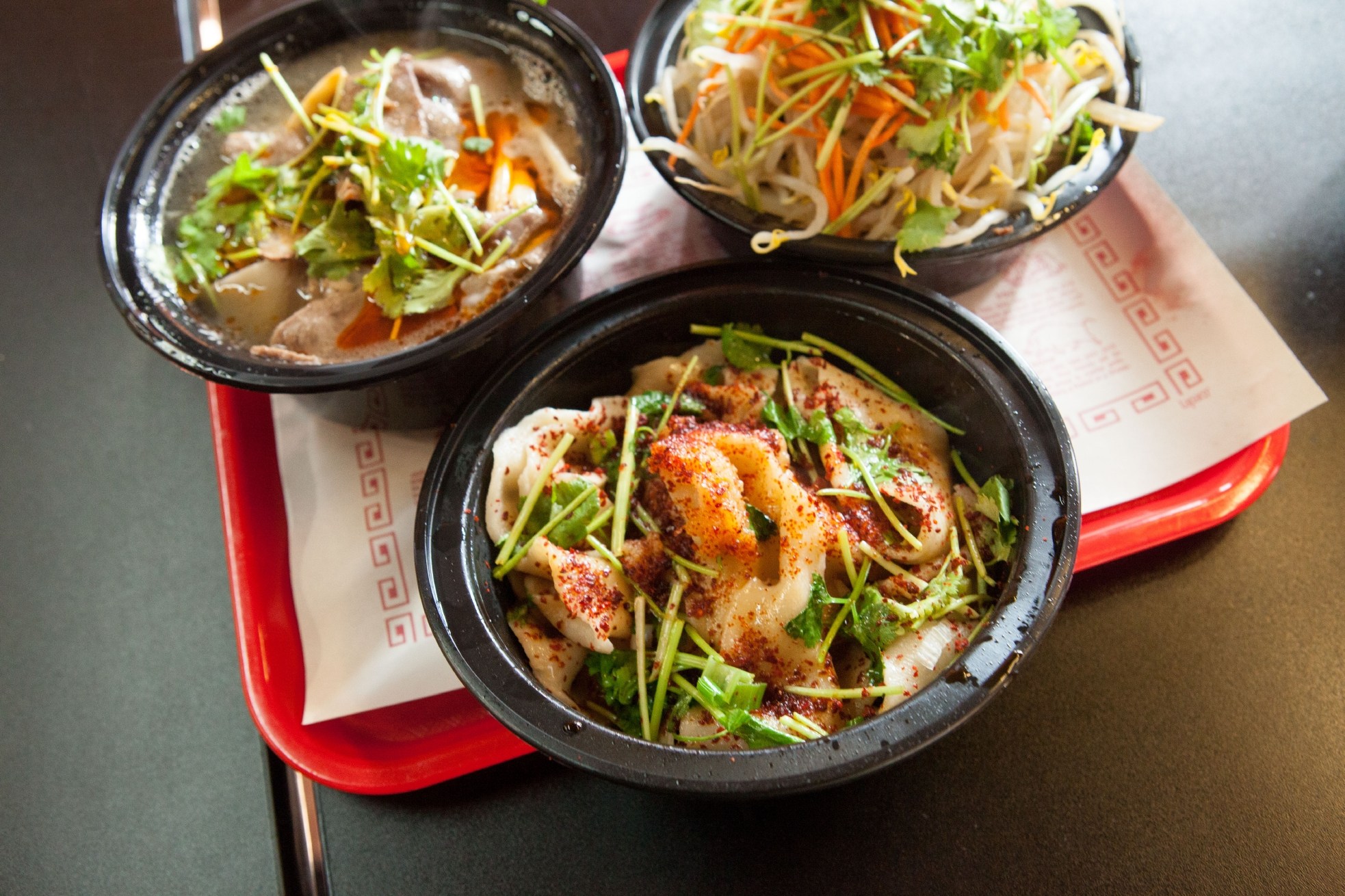 From top left, Lamb Pulled Noodles Soup, Cumin Hand-Pulled Noodle, and Hand Pulled Noodle at Gene’s Chinese Flatbread Café in Boston, MA.