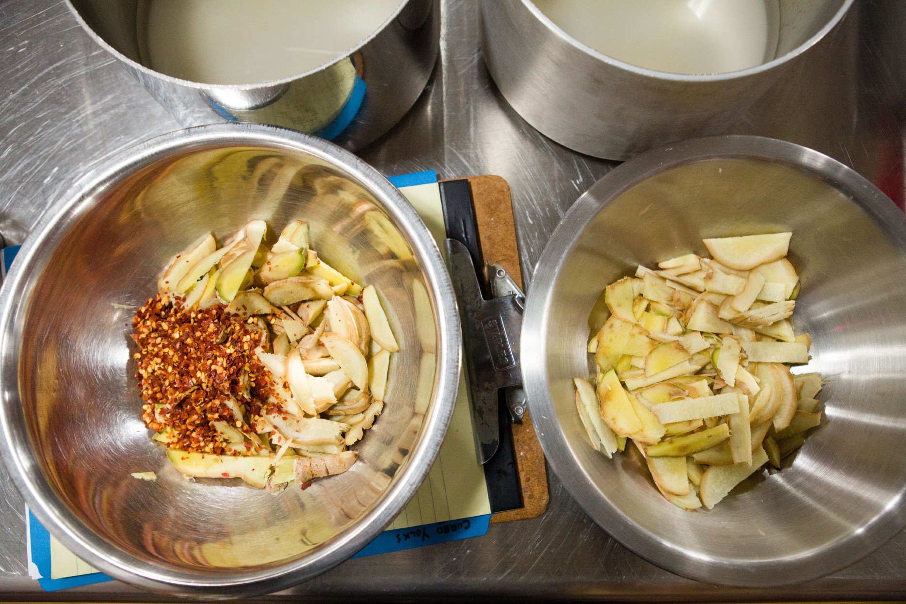 Sliced ginger with and without chili flakes sit ready to use as associate editor Tim Chin tests how to reintroduce some of the heat that is lost as the root ages.
